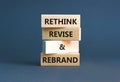 Rethink revise rebrand symbol. Concept word Rethink Revise and Rebrand on beautiful block. Beautiful grey background. Business Royalty Free Stock Photo