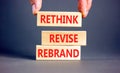 Rethink revise rebrand symbol. Concept word Rethink Revise Rebrand on beautiful block. Beautiful grey table grey background.