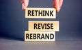 Rethink revise rebrand symbol. Concept word Rethink Revise Rebrand on beautiful block. Beautiful grey table grey background.