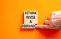 Rethink revise rebrand symbol. Concept word Rethink Revise and Rebrand on beautiful block. Beautiful orange background. Business Royalty Free Stock Photo