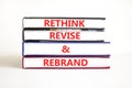 Rethink revise rebrand symbol. Concept word Rethink Revise and Rebrand on beautiful book. Beautiful white table white background.