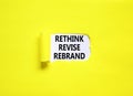 Rethink revise rebrand symbol. Concept word Rethink Revise Rebrand on beautiful white paper. Beautiful yellow table background.