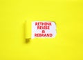 Rethink revise rebrand symbol. Concept word Rethink Revise and Rebrand on beautiful white paper. Beautiful yellow background.