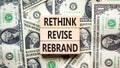 Rethink revise rebrand symbol. Concept word Rethink Revise Rebrand on block. Dollar bills. Beautiful dollar bills background. Royalty Free Stock Photo