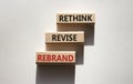 Rethink Revise Rebrand symbol. Wooden blocks with words Rethink Revise Rebrand. Beautiful white background. Business and Rethink
