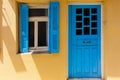 Rethymno, Island Crete, Greece, - June 23, 2016: Traditional Greek house with window with blue shutters and wood door Royalty Free Stock Photo