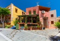 Rethymnon, Island Crete, Greece, - July 1, 2016: Cosy cretan small cafe with flowers outside with ad on the green board about