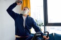 retired adult man doing physical cardio exercise on fitness bicycle, drinking water exhausted Royalty Free Stock Photo