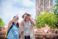 Retired couple traveling at temple in Thailand.