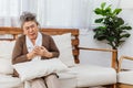 Retired Asian senior elderly grandmother or woman pain from heart attack disease or illness without no one nursing at home. Royalty Free Stock Photo