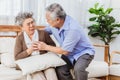 Retired Asian senior elderly wife pain from heart attack disease or illness with serious or worried husband take care at home. Royalty Free Stock Photo