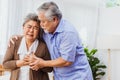 Retired Asian senior elderly wife pain from heart attack disease or illness with serious or worried husband take care at home. Royalty Free Stock Photo