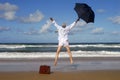 Retired business man jumping with happiness on a tropical beach, retirement freedom concept Royalty Free Stock Photo