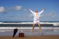 Retired businessman jumping with happiness on a beautiful tropical beach, retirement freedom concept