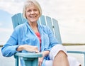 Retired but certainly not tired. Portrait of a happy senior woman relaxing on a chair outside. Royalty Free Stock Photo