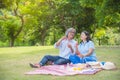 Retired couple blowing bubbles in park