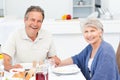 Retired couple eating in the kitchen Royalty Free Stock Photo