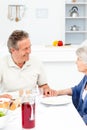 Retired couple eating in the kitchen Royalty Free Stock Photo