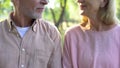 Retired couple looking each other, romantic date outdoor, relation closeness