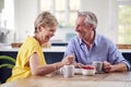 Retired Couple Sitting Around Table At Home Having Healthy Breakfast Together Royalty Free Stock Photo