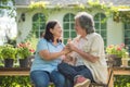 Retired couple sitting in front of their house and smile Royalty Free Stock Photo