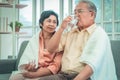 Retired couple is taking care of each other by reminding them to take medicine in cold winter