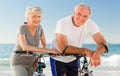 Retired couple with their bikes on the beach Royalty Free Stock Photo