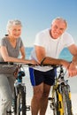 Retired couple with their bikes on the beach Royalty Free Stock Photo