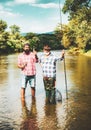 Retired dad and mature bearded son. Happy bearded fishers in water. Men relaxing nature background. Brutal man stand in Royalty Free Stock Photo