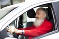Senior  man with long beard driving gray car Royalty Free Stock Photo