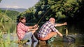 retired father and mature bearded son. big game fishing. relax on nature. fly fish hobby of men. retirement fishery Royalty Free Stock Photo