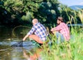 Retired father and mature bearded son. big game fishing. relax on nature. Two male friends fishing together. fishermen Royalty Free Stock Photo