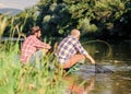 retired father and mature bearded son. big game fishing. relax on nature. Two male friends fishing together. fishermen Royalty Free Stock Photo