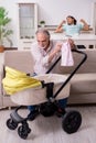 Retired grandfather looking after newborn at home