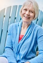 Retired and having the time of my life. Portrait of a happy senior woman relaxing on a chair outside. Royalty Free Stock Photo