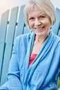 Retired just the way Id hoped to. Portrait of a happy senior woman relaxing on a chair outside. Royalty Free Stock Photo