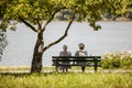 Retired ladies sitting on the bench enjoying Danube river