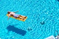 Retired lifestyle beautiful man senior age relaxing and enjoying the blue water pool sleeping on a orange coloured trendy lilo in