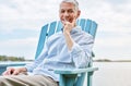 Retired and living life in the slow lane. Portrait of a happy senior man relaxing on a chair outside. Royalty Free Stock Photo