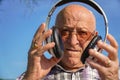 retired man bald portrait with headphones listening music Royalty Free Stock Photo