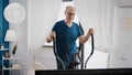 Retired man doing cardio exercise with stationary bicycle Royalty Free Stock Photo