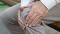 Retired man hardly getting up from bench, pain in joints, problems with knees