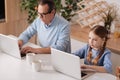 Retired man and little girl surfing the Internet at home Royalty Free Stock Photo