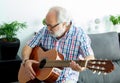 Retired man playing guitar Royalty Free Stock Photo