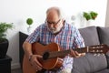 Retired man playing guitar Royalty Free Stock Photo