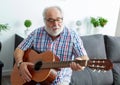 Retired man playing guitar Royalty Free Stock Photo