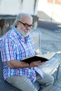 Retired man reading a book Royalty Free Stock Photo