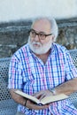 Retired man reading a book Royalty Free Stock Photo