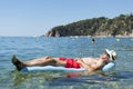 Retired man sleeping on bed in sea water