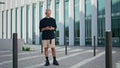 Retired man typing smartphone at downtown. Pensive mature male using mobile Royalty Free Stock Photo